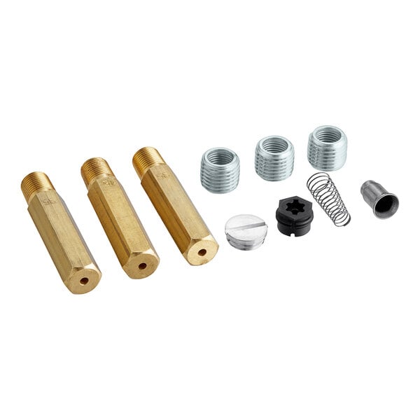 A close-up of brass and metal Frymaster conversion parts.