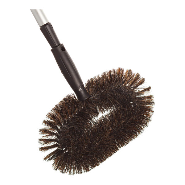 A large oval-shaped duster brush with dark bristles and a black handle attachment.