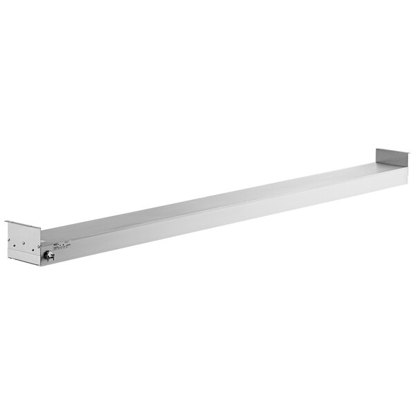 A white rectangular object with a silver metal top and a long metal shelf.