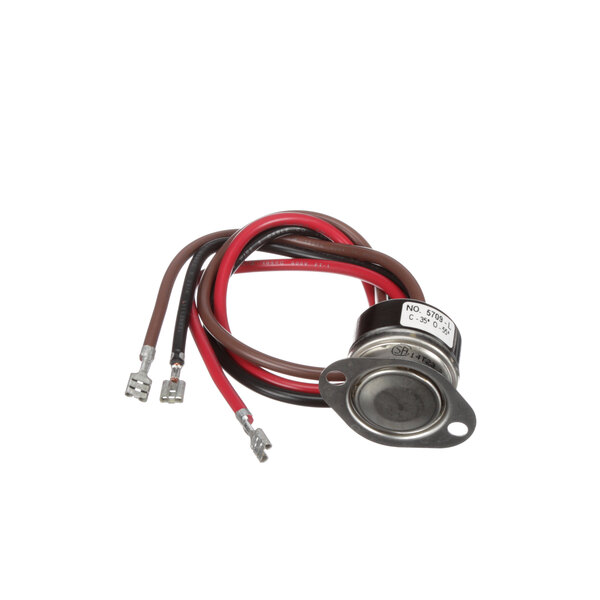 A close-up of a Norlake defrost switch with red, black, and white wires.