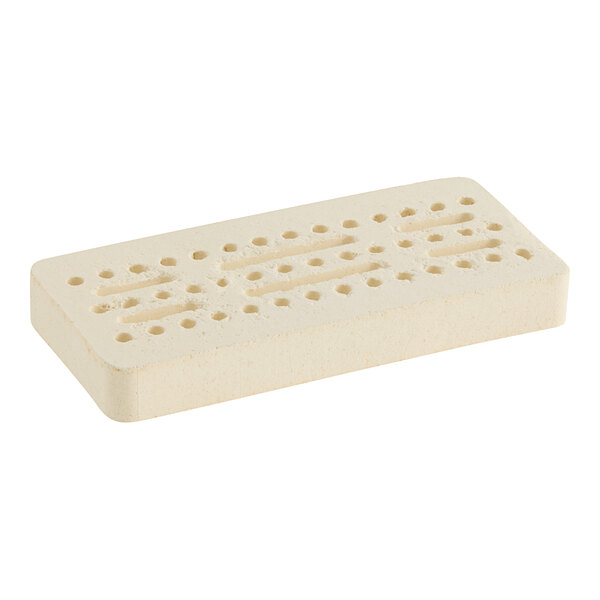 A white rectangular ceramic radiant with holes in it.