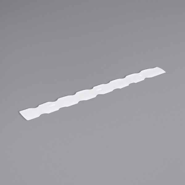 A white plastic Cornelius Blade Scraper Viper strip on a gray surface