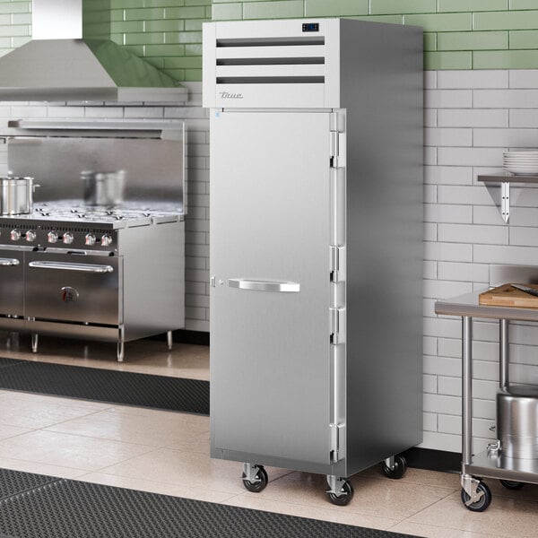 A stainless steel True Spec Series reach-in refrigerator with a white door handle.
