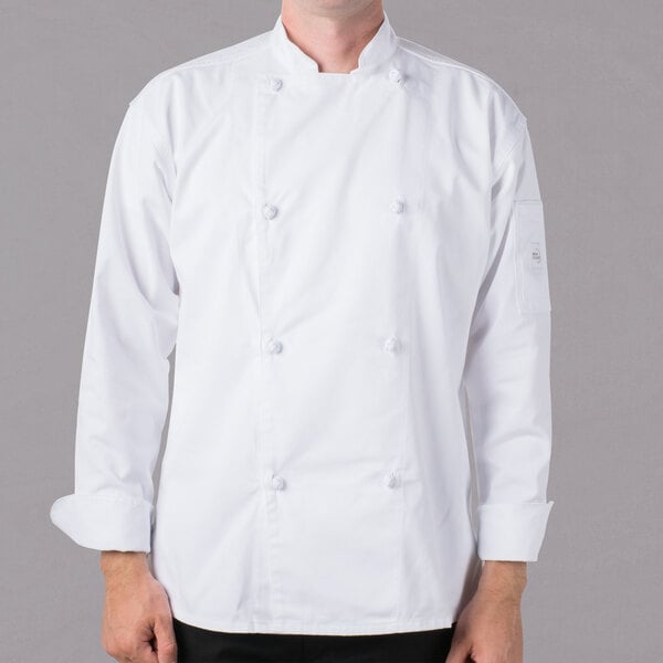 A man wearing a white Mercer Culinary long sleeve chef jacket with cloth knot buttons.