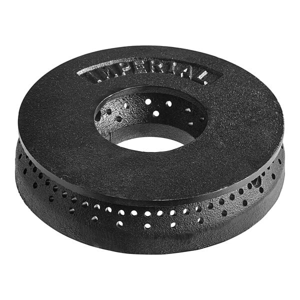 A black circular metal burner head with holes in it.