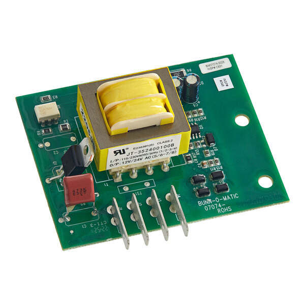 A green circuit board with a yellow electrical component.