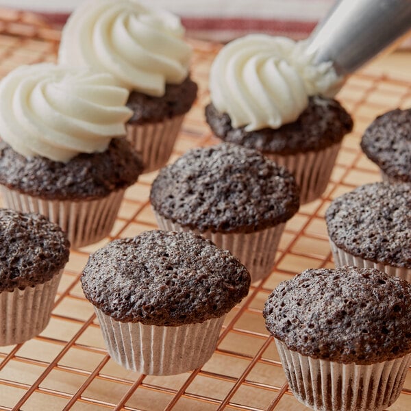 A chocolate muffin on a cooling rack.