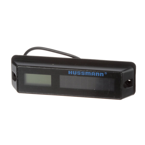 A black rectangular Hussmann thermometer with a digital display.