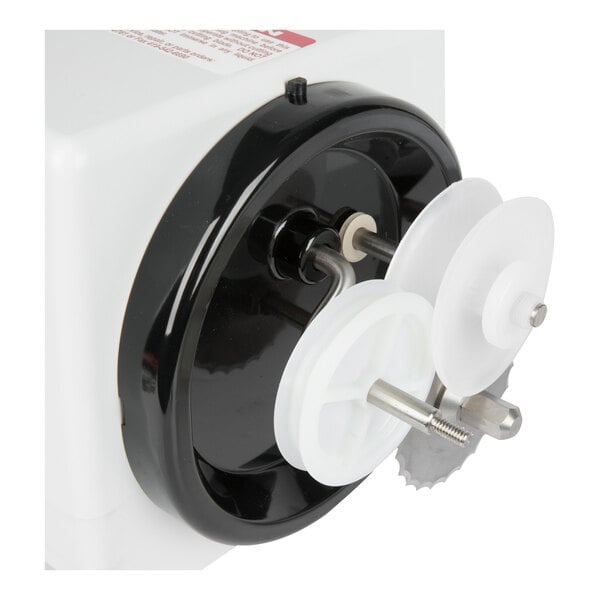 A close-up view of a mechanical device with white and black plastic components and a metal shaft, featuring circular rollers and a serrated metal blade.