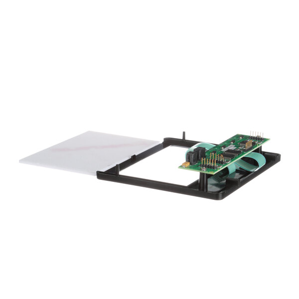A green circuit board with a white sheet on a table.
