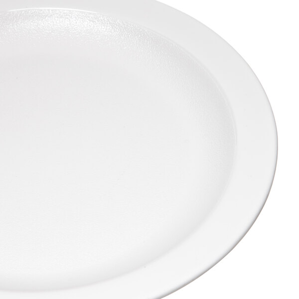 A close up of a white Carlisle polycarbonate plate with a narrow white rim.
