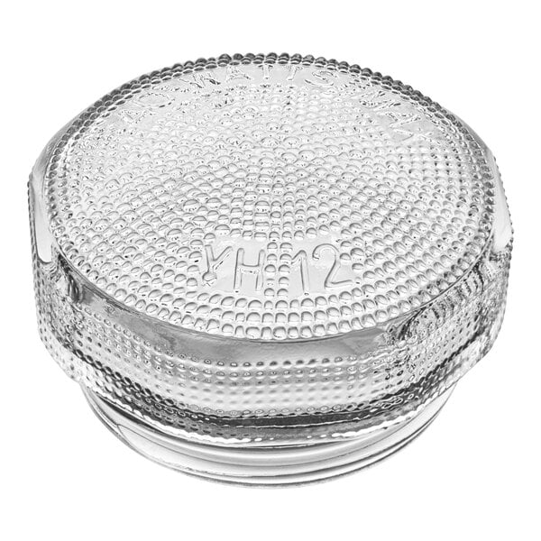 A clear glass container with a clear glass lid with a number on it.