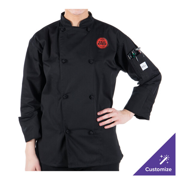 A woman wearing a black Mercer Culinary long sleeve chef jacket with cloth knot buttons.