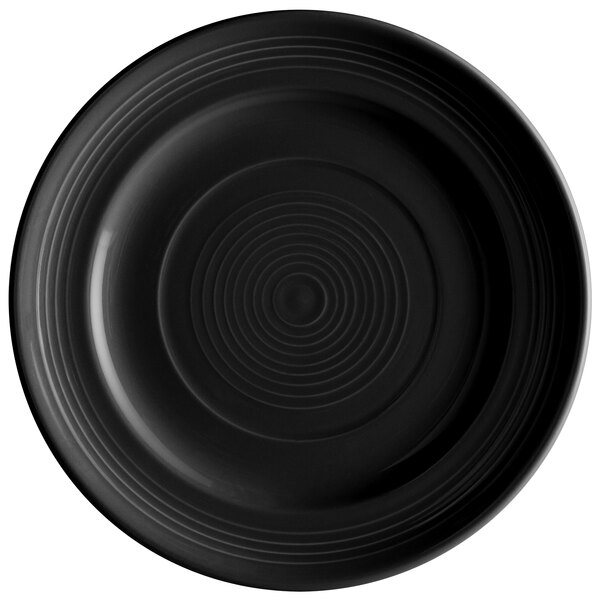 A black Tuxton Concentrix china plate with a spiral pattern in the middle.