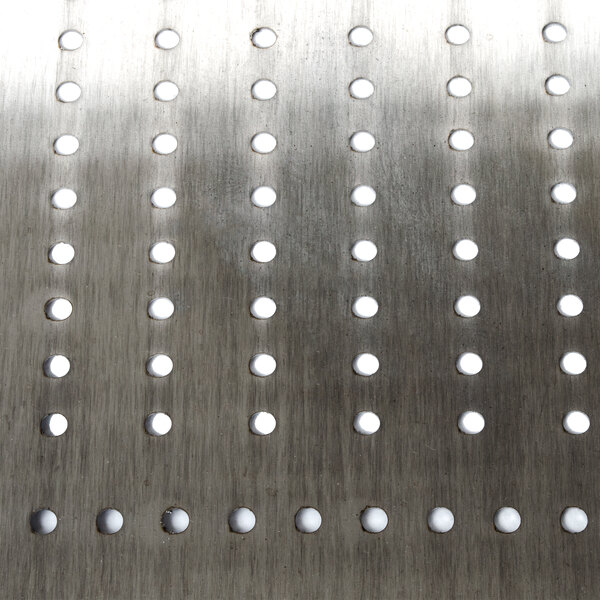 A metal Advance Tabco pre-rinse basket with holes in it.