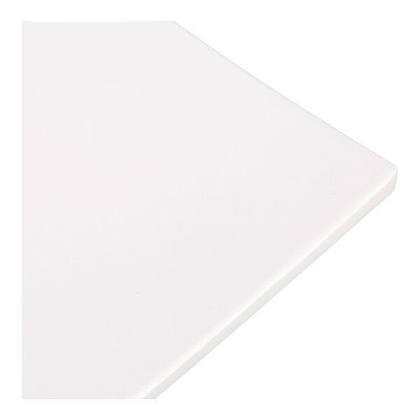 A close-up view of a white, square, flat surface with slightly raised edges.
