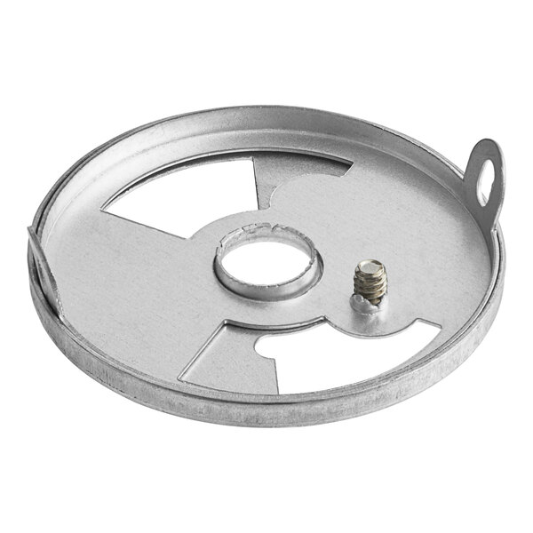 A round metal plate with a screw and screwdriver.