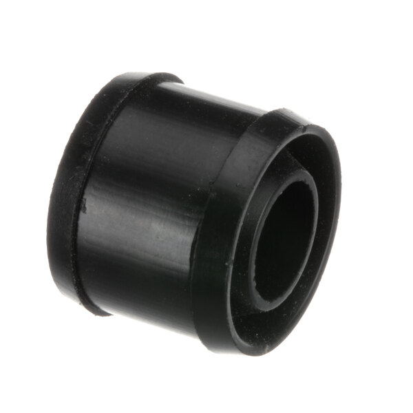 A close-up of a black rubber Taylor shaft seal with a hole in it.