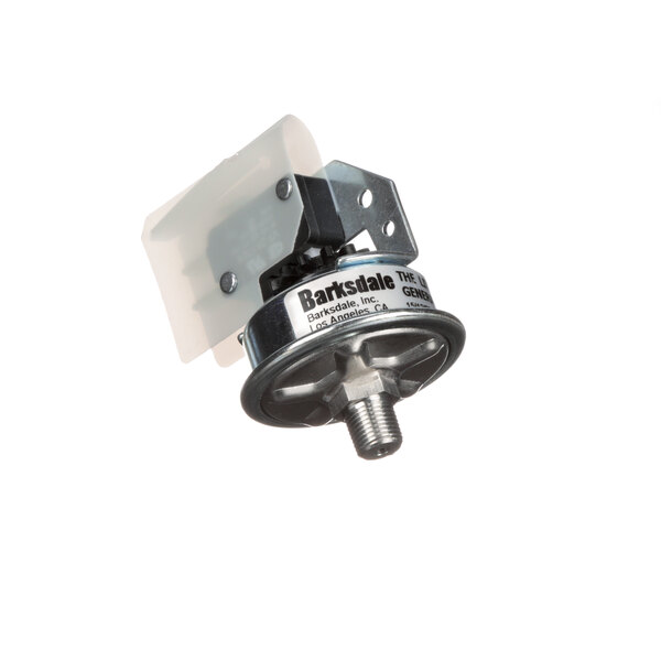 A close-up of a metal Crown Steam pressure switch.
