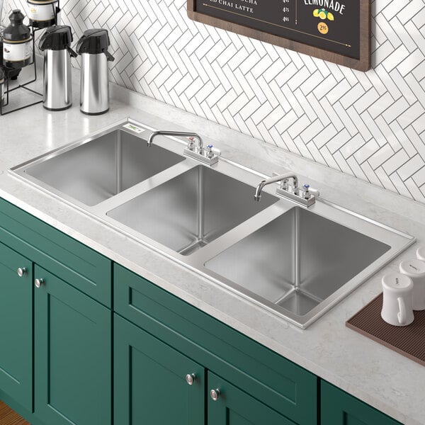 A Regency stainless steel drop-in sink with three compartments.