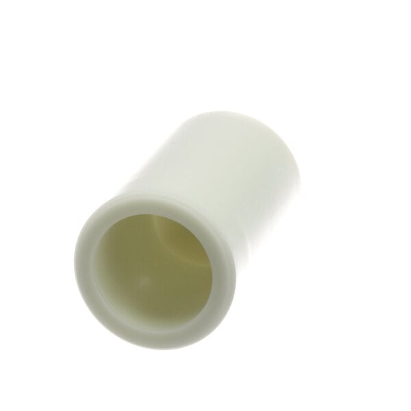 A white plastic tube with a hole in it.