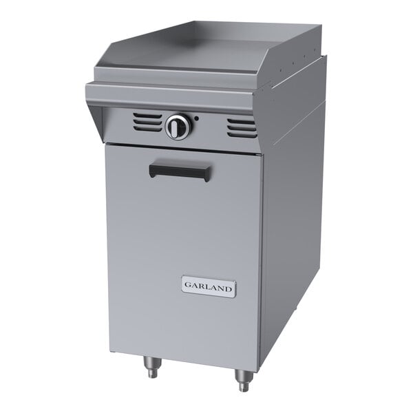 A stainless steel natural gas griddle attachment with a storage base and manual controls.
