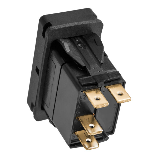 A black rectangular electrical switch with four gold-colored metal prongs.
