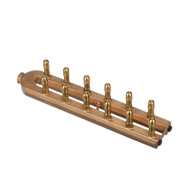 A close-up of a Groen brass manifold with six holes.
