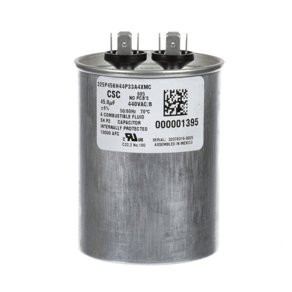 A round metal Manitowoc Ice capacitor with two wires and a white label.