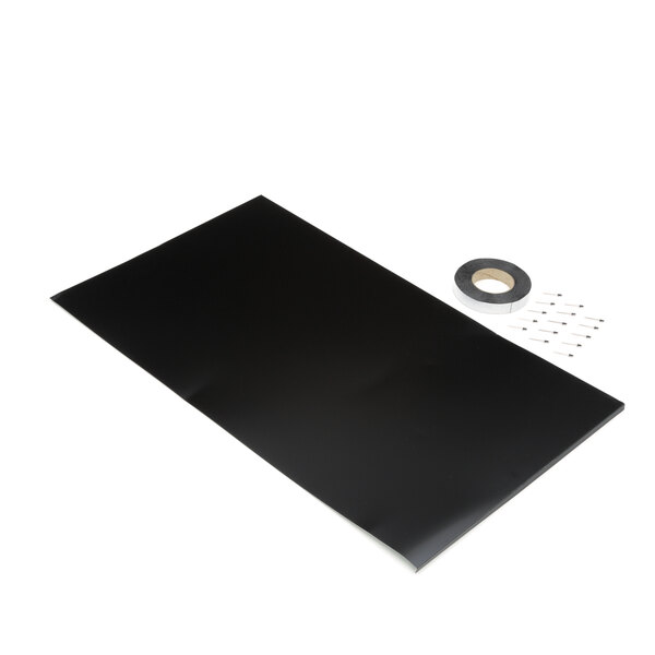 A black rectangular cap kit with a roll of tape and pins.