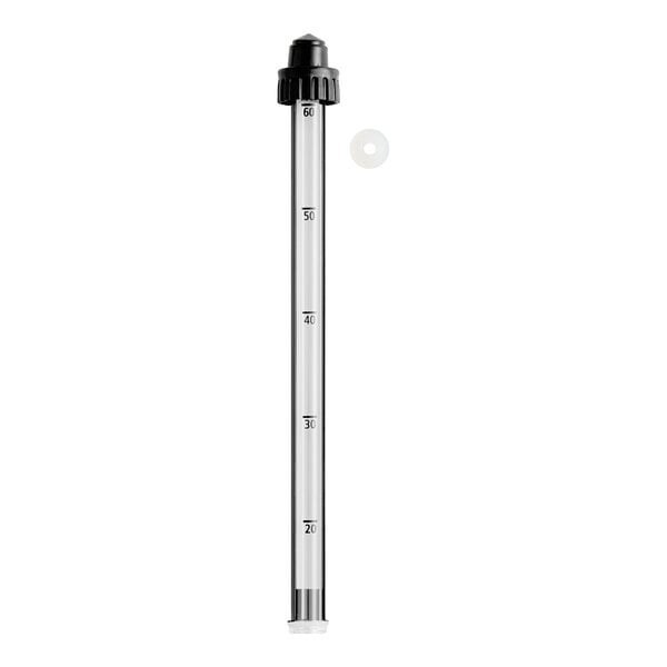 A close-up of a Hamilton Beach water gauge, a white cylinder with black lines, a glass tube with a black cap and a pointy black plastic cap.