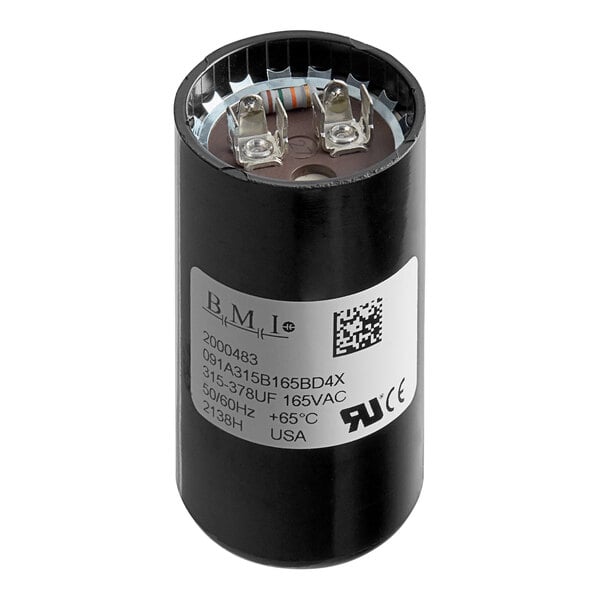 A close-up of a black Manitowoc Ice start capacitor.