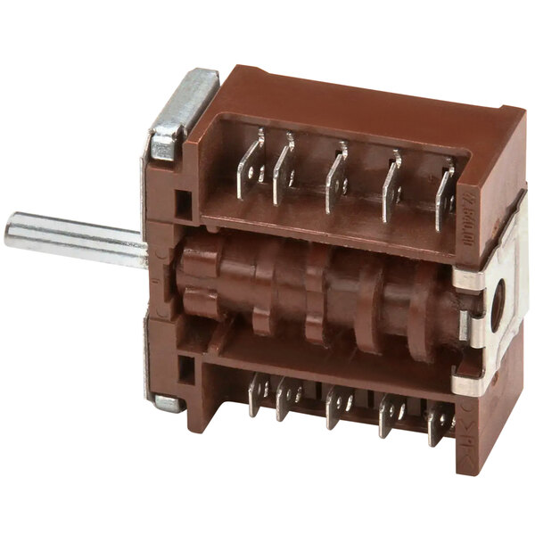A brown rectangular APW Wyott rotary switch with metal pins.