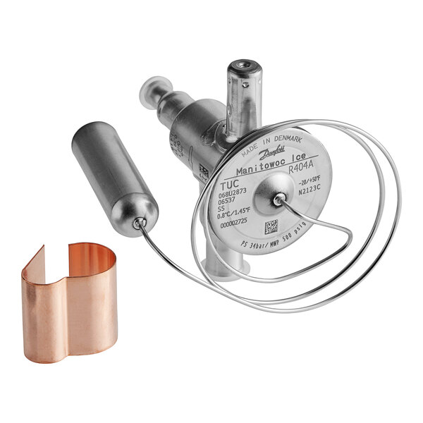 A close-up of a Manitowoc Ice expansion valve with a copper pipe.