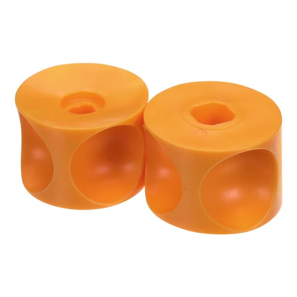 A pair of orange plastic Zumex upper pressing units with holes in them.