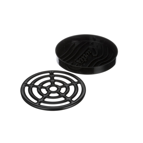A black circular tray with a round design on it.