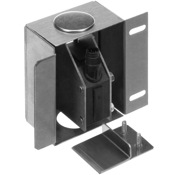 A close-up of a metal box with a black and silver object inside.