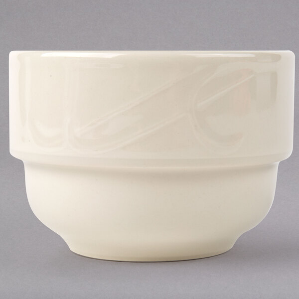 A close up of a Homer Laughlin ivory china bouillon cup with a handle.