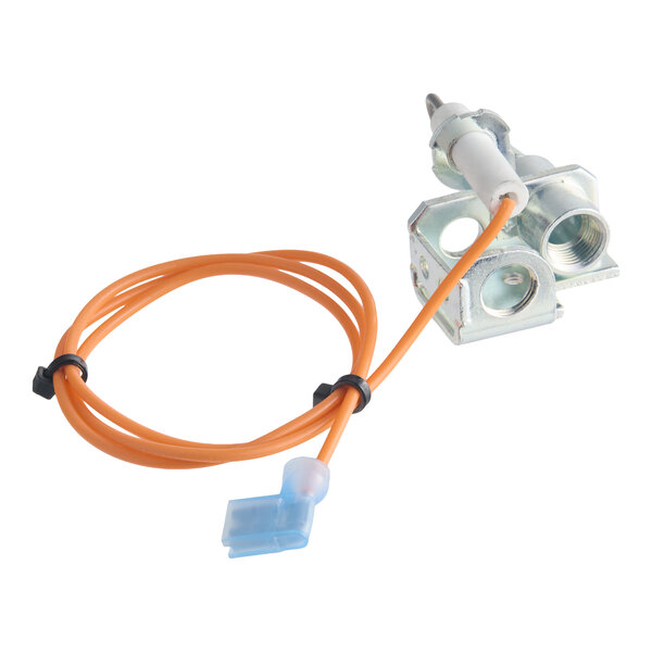 A metal component with an attached orange wire and blue connector, featuring threaded openings and a white ceramic part.