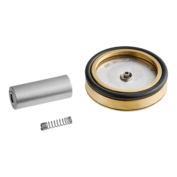 A Hobart solenoid valve kit with brass and gold metal parts, a metal tube, and spring on a table.