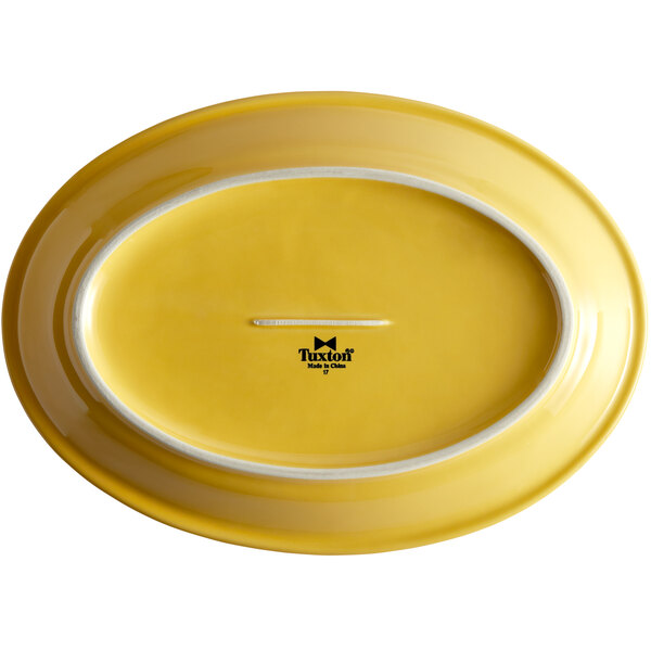 A yellow oval platter with a white rim.
