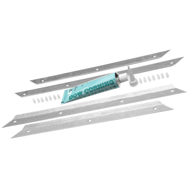 A tube of glue and metal strips on a metal surface.