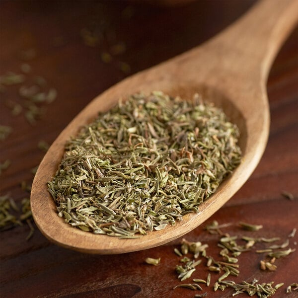 Dried thyme leaves on a wooden spoon