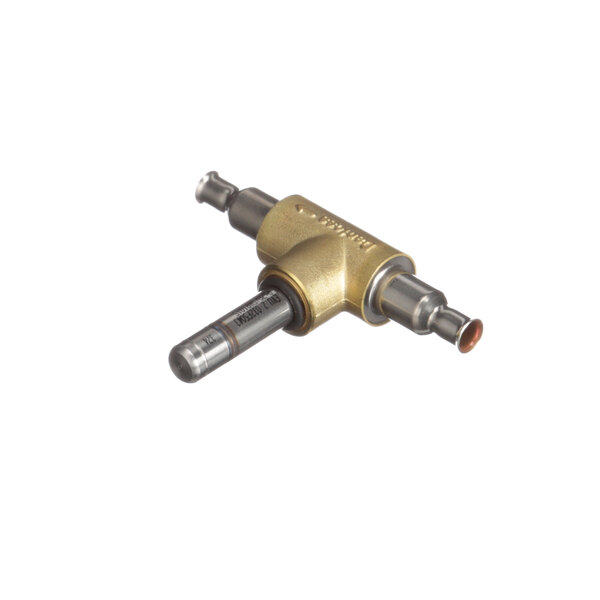 A close up of a Franke solenoid valve body. A brass metal tool with a small hole.