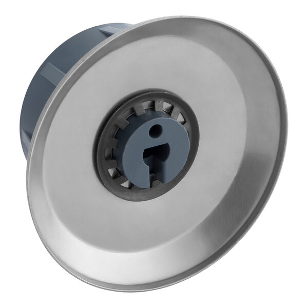 A round metallic and plastic knob with a central slot and gear-like inner ring, likely used for adjusting a thermostat.