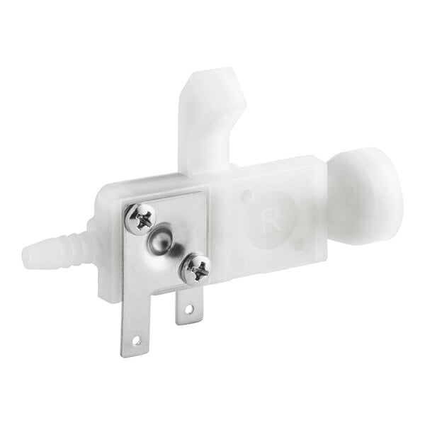 A white plastic device with a metal plate and screws.