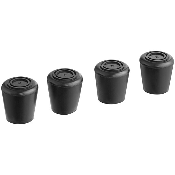 Four black rubber tips on a table.