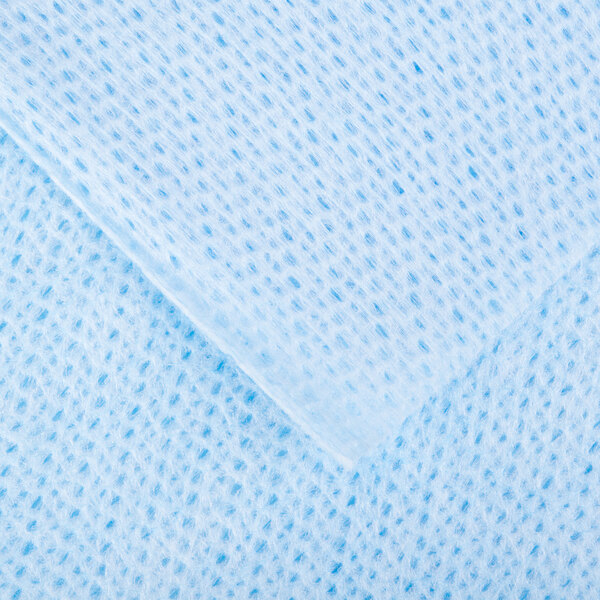 A close up of a blue fabric with small holes.