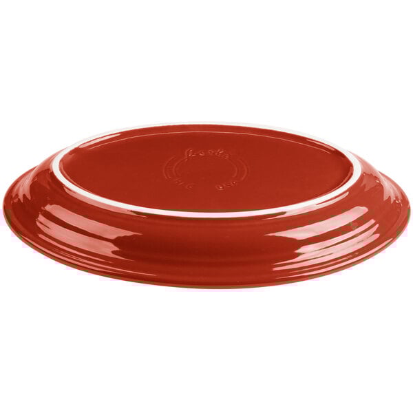 A red Fiesta china platter with a white rim.