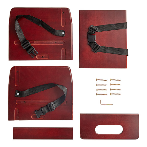 A Lancaster Table & Seating wooden booster seat with black straps on a red surface.